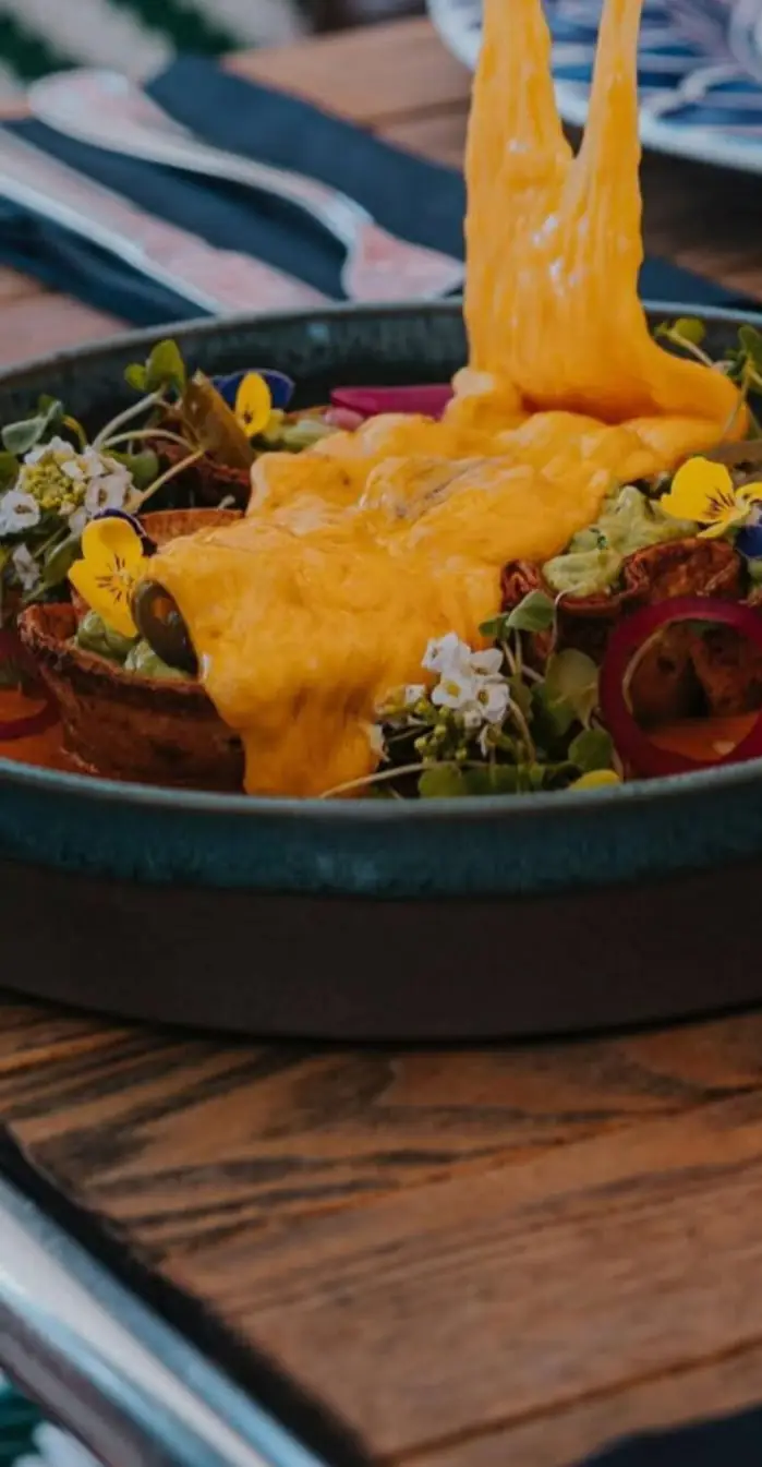 Raclette poured over a dish on the terrace