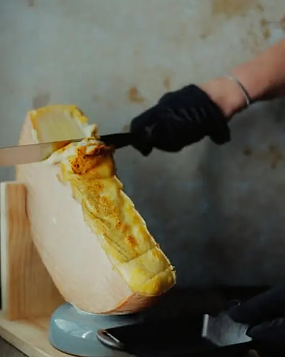 Raclette scraped from the cheese wheel