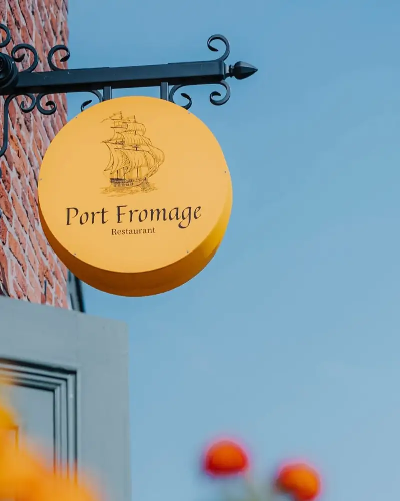 Golden Port Fromage sign with a ship